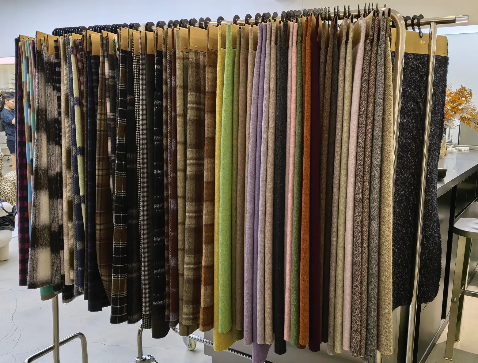 Wide view of a fabric sample rack with double-faced wool swatches in many colours