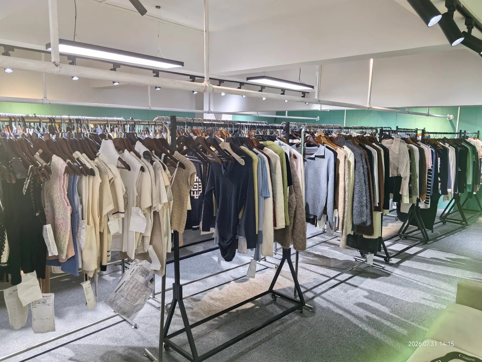A showroom rail displaying selected wool and cashmere coats in neutral tones